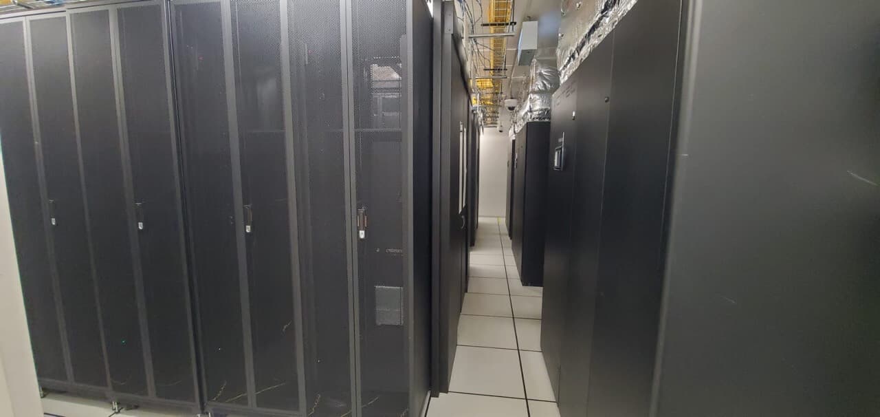 Professional data center server aisle with black cabinets and organized cable management system