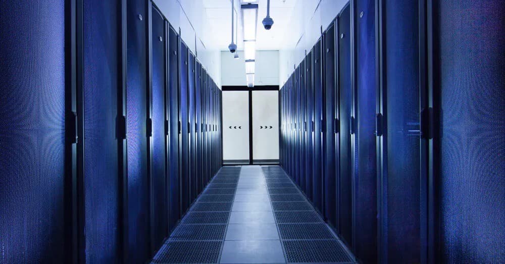 Blue server cabinet corridor with symmetrical arrangement, advanced cooling design and secure access controls for enterprise-grade hosting