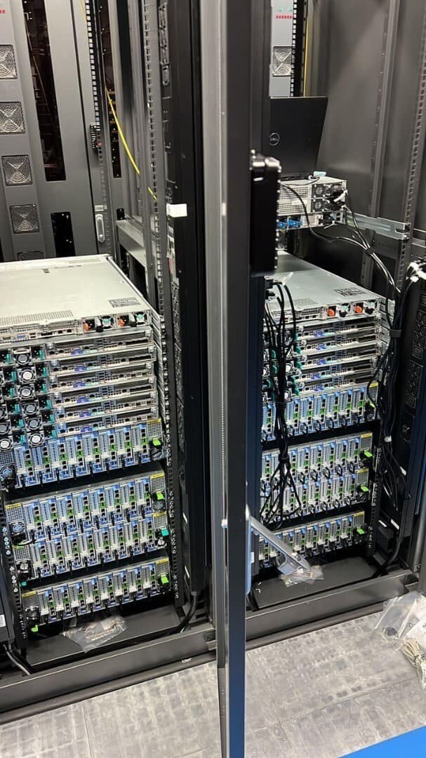 Close-up of enterprise server hardware with redundant power supplies, cooling fans and status indicator lights in rack-mounted configuration