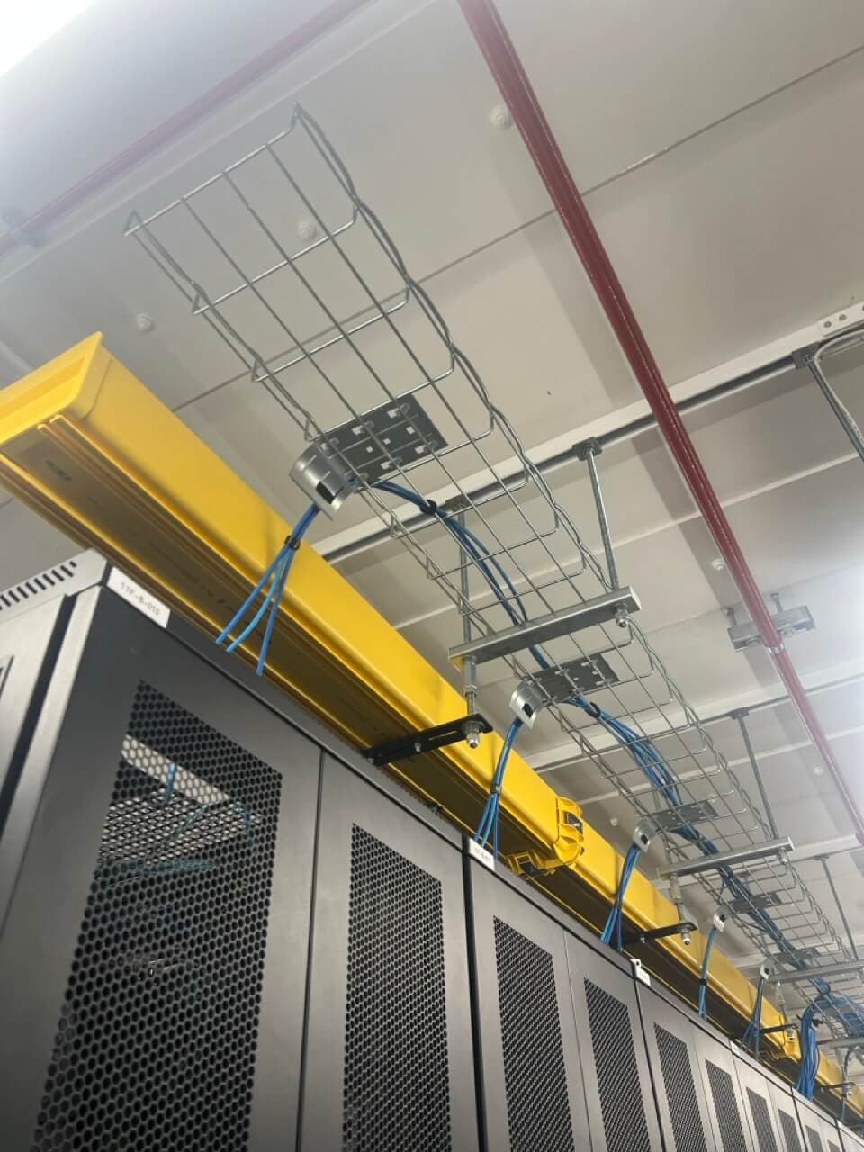 Industrial-grade cable management system with overhead trays ensuring reliable connectivity