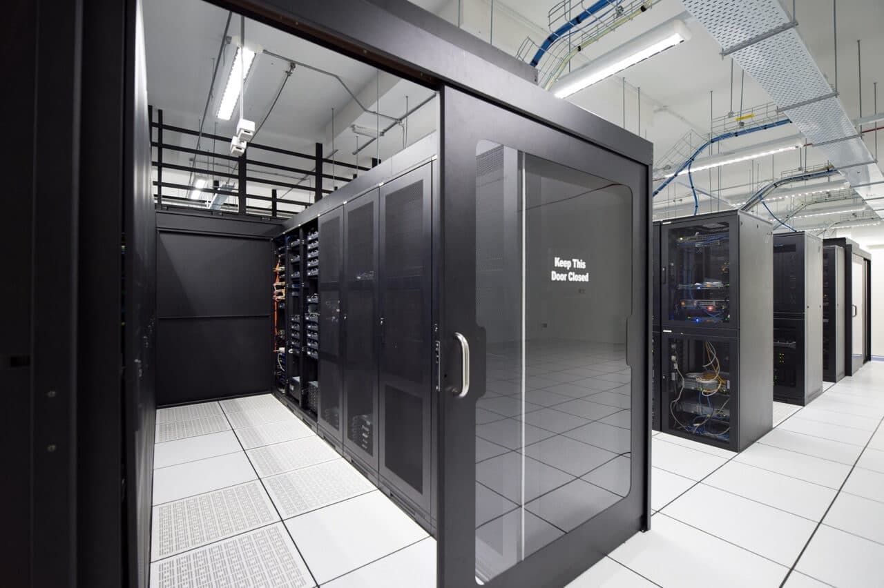 Secure data center environment with glass door access and visible "Keep This Door Closed" security notice