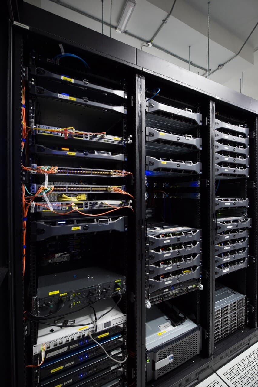 Close-up of enterprise server equipment with color-coded network cables and connection points