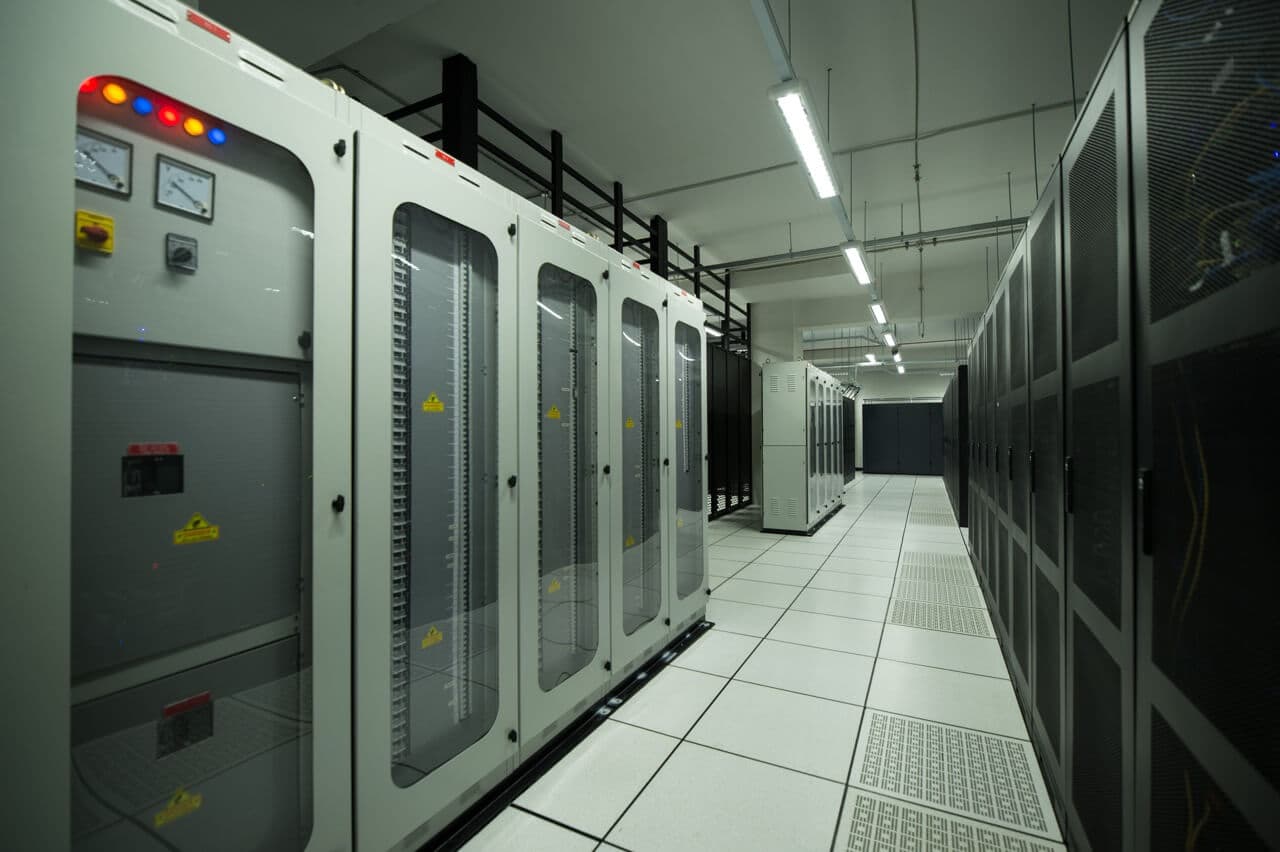 Power distribution and cooling infrastructure hallway with safety indicators and monitoring systems