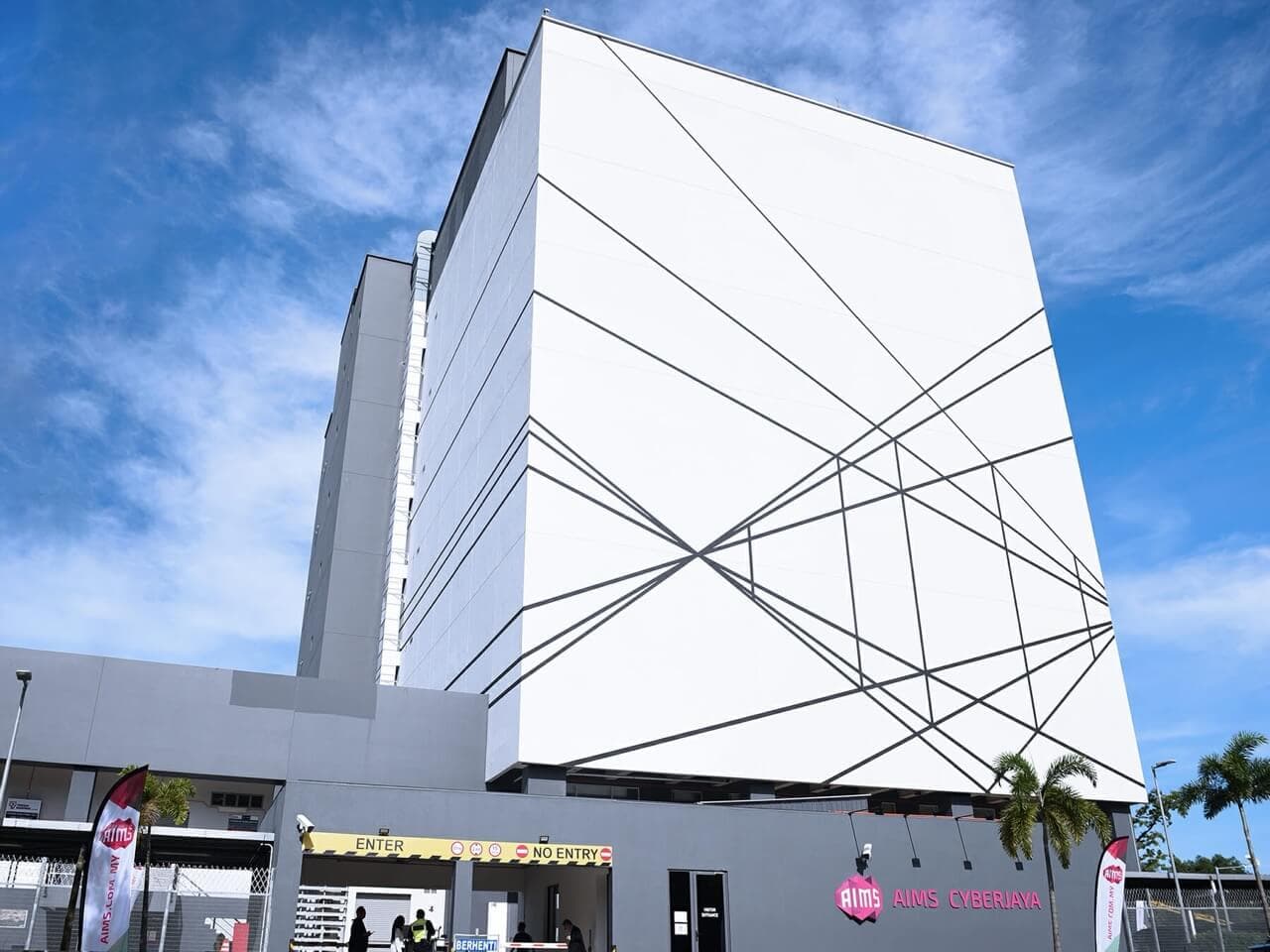 Contemporary white data center building with geometric architectural design against blue sky
