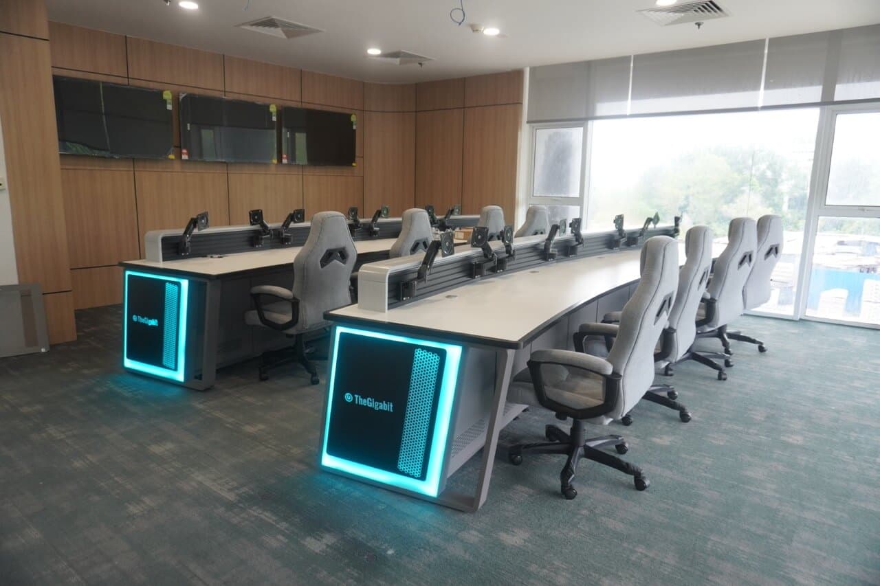 Network operations center with modern workstations, illuminated desks and monitoring capabilities