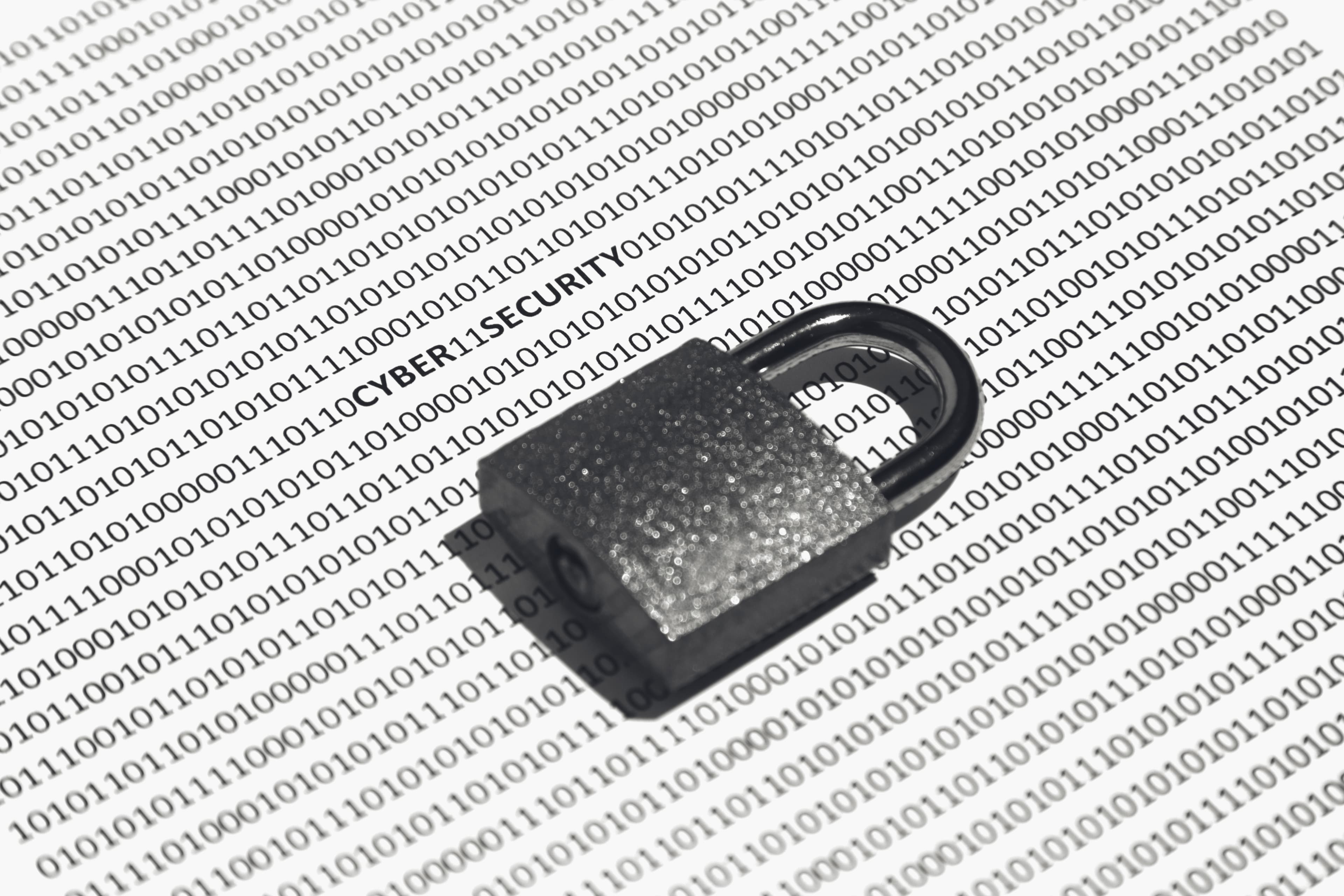 Closeup shot of a lock on a white surface with binary code on it.