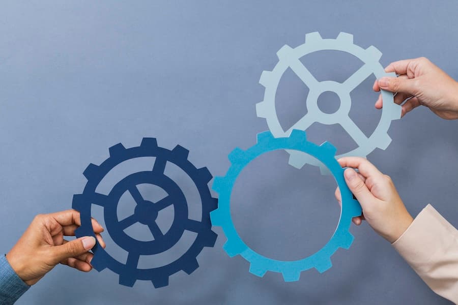Multiple hands holding interlocking gears, symbolizing the configuration and integration of system components. Multiple hands holding interlocking gears, symbolizing the configuration and integration of system components.