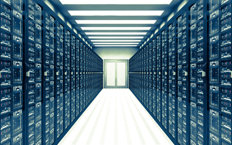 Wide hallway in a data center with endless rows of server racks on both sides, leading to a bright white light at the end. The scene conveys high-tech efficiency. Wide hallway in a data center with endless rows of server racks on both sides, leading to a bright white light at the end. The scene conveys high-tech efficiency.