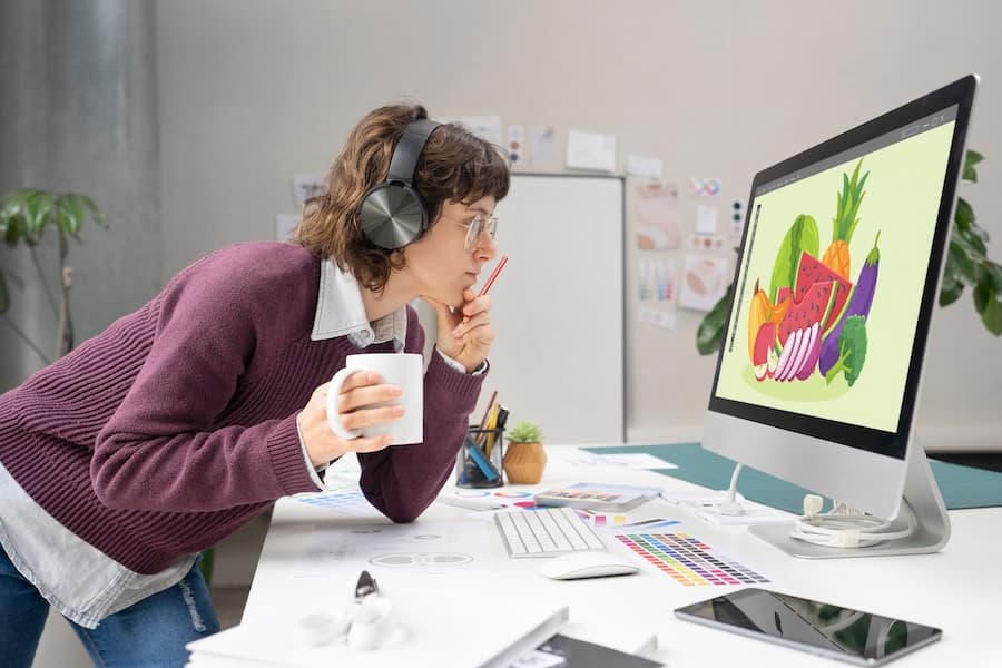 A designer analyzing colorful graphics on a computer monitor, representing the design phase of a project workflow. A designer analyzing colorful graphics on a computer monitor, representing the design phase of a project workflow.