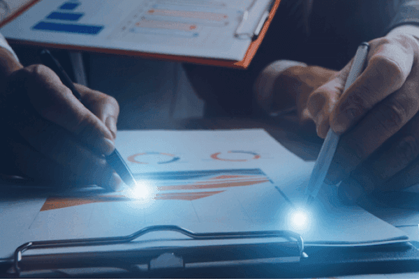 Illustration of a business meeting in a room with wall charts. Four people, seated and one standing, discuss data including graphs and statistics. Professional tone. Illustration of a business meeting in a room with wall charts. Four people, seated and one standing, discuss data including graphs and statistics. Professional tone.