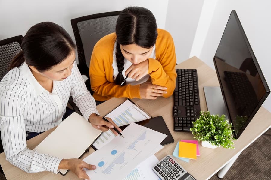 Two professionals reviewing documents at a desk, demonstrating our dedicated consulting services for financial sector hosting needs. Two professionals reviewing documents at a desk, demonstrating our dedicated consulting services for financial sector hosting needs.