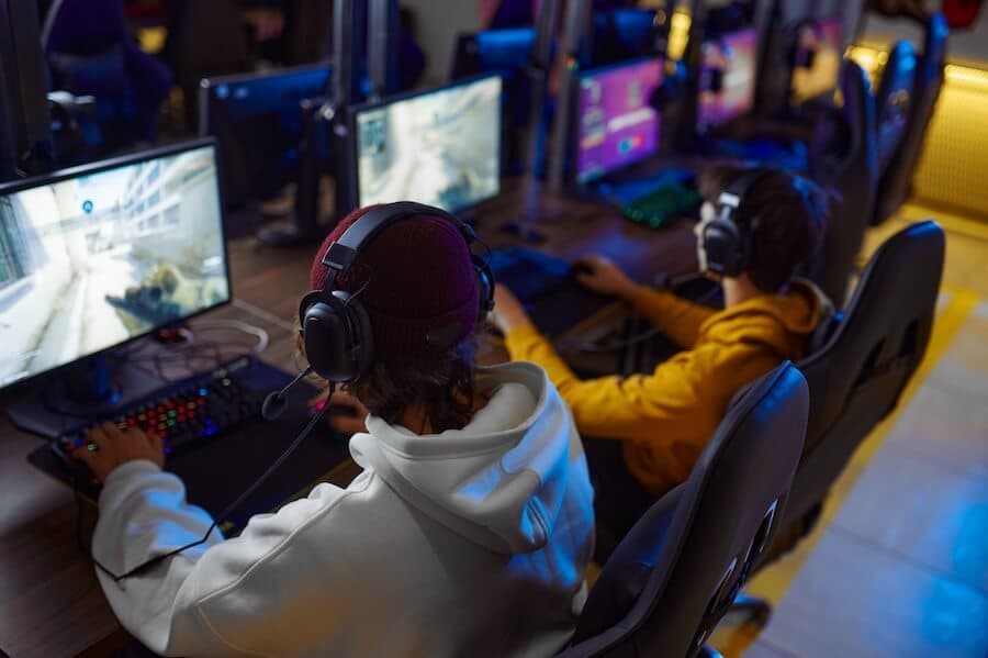 A group of gamers at a LAN party, each using high-performance computers, representing gaming server hosting for smooth gameplay. A group of gamers at a LAN party, each using high-performance computers, representing gaming server hosting for smooth gameplay.