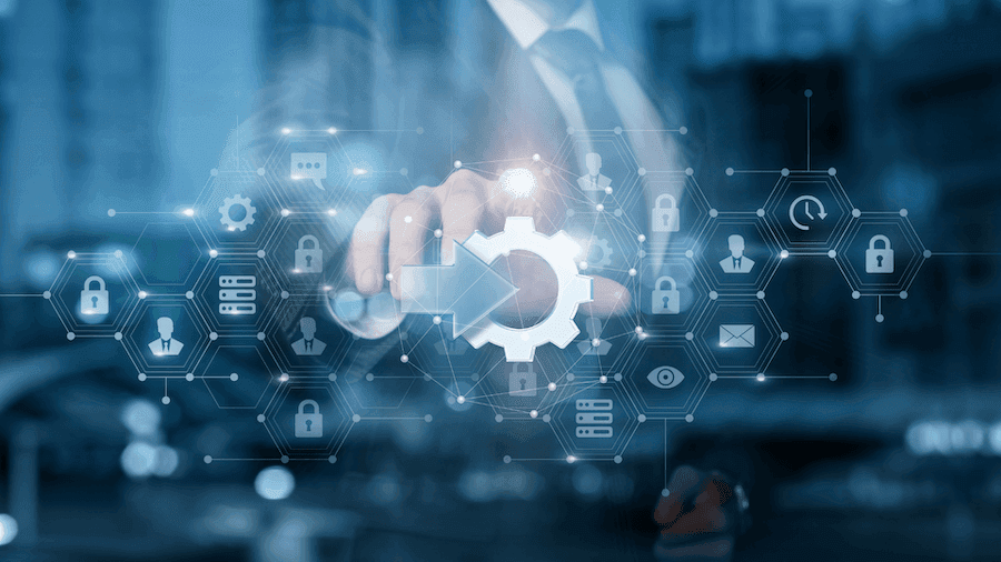 A person in a suit interacts with a digital interface, featuring a large gear icon surrounded by symbols like locks and chat bubbles, conveying technology and security themes. A person in a suit interacts with a digital interface, featuring a large gear icon surrounded by symbols like locks and chat bubbles, conveying technology and security themes.