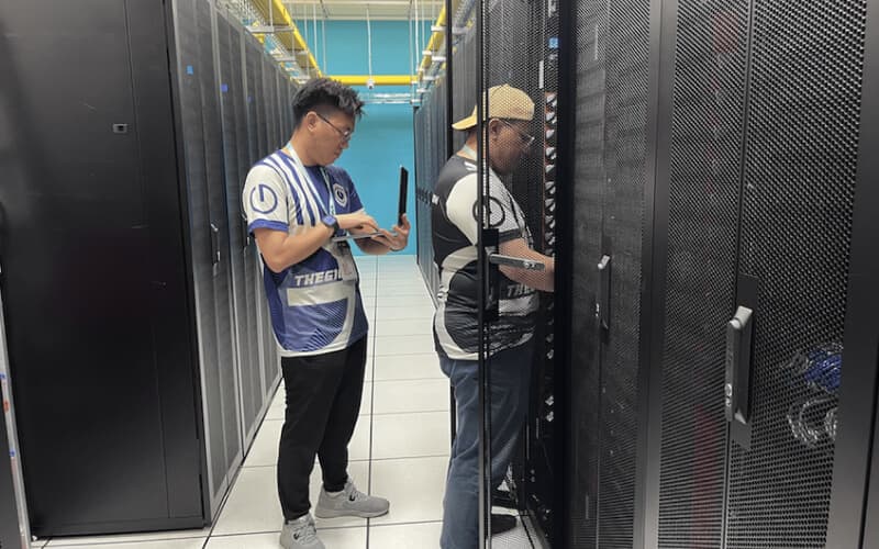 Two technicians discussing server configurations in a data center, highlighting dedicated server management services. Two technicians discussing server configurations in a data center, highlighting dedicated server management services.