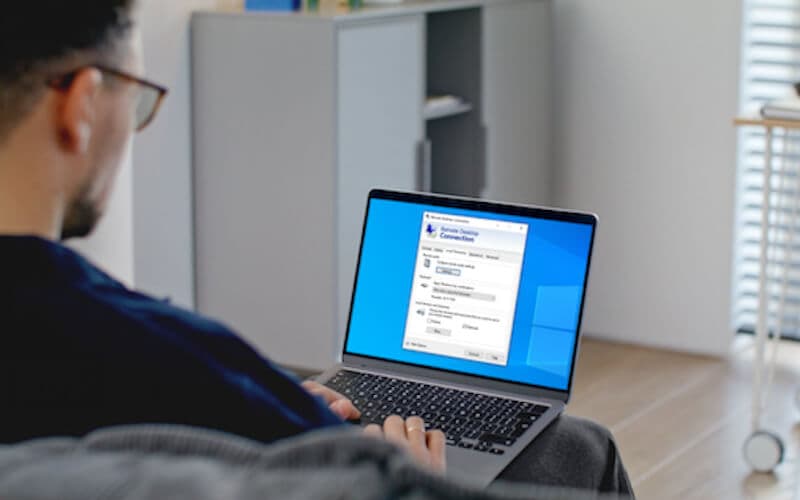 A person using a laptop with a remote desktop interface, representing cloud-based Windows workstations for remote access to enterprise software. A person using a laptop with a remote desktop interface, representing cloud-based Windows workstations for remote access to enterprise software.