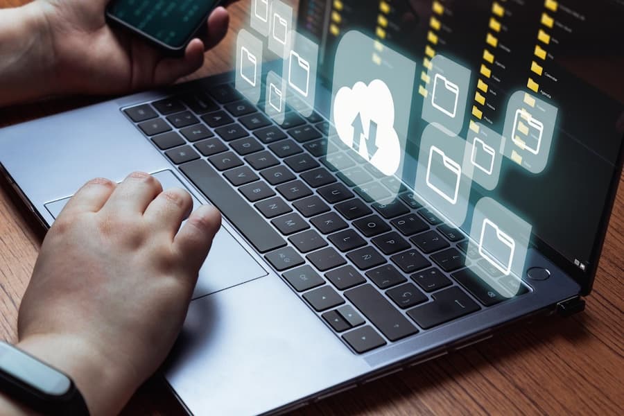 Hand accessing cloud backup interface on laptop keyboard, representing our user-friendly self-service backup platform. Hand accessing cloud backup interface on laptop keyboard, representing our user-friendly self-service backup platform.