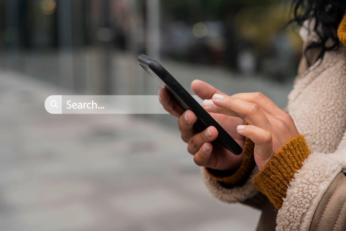 Photo of a lady using smartphone with a visual of floating search bar. Photo of a lady using smartphone with a visual of floating search bar.